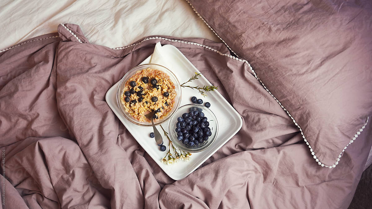 breakfast in bed of porridge and blueberries