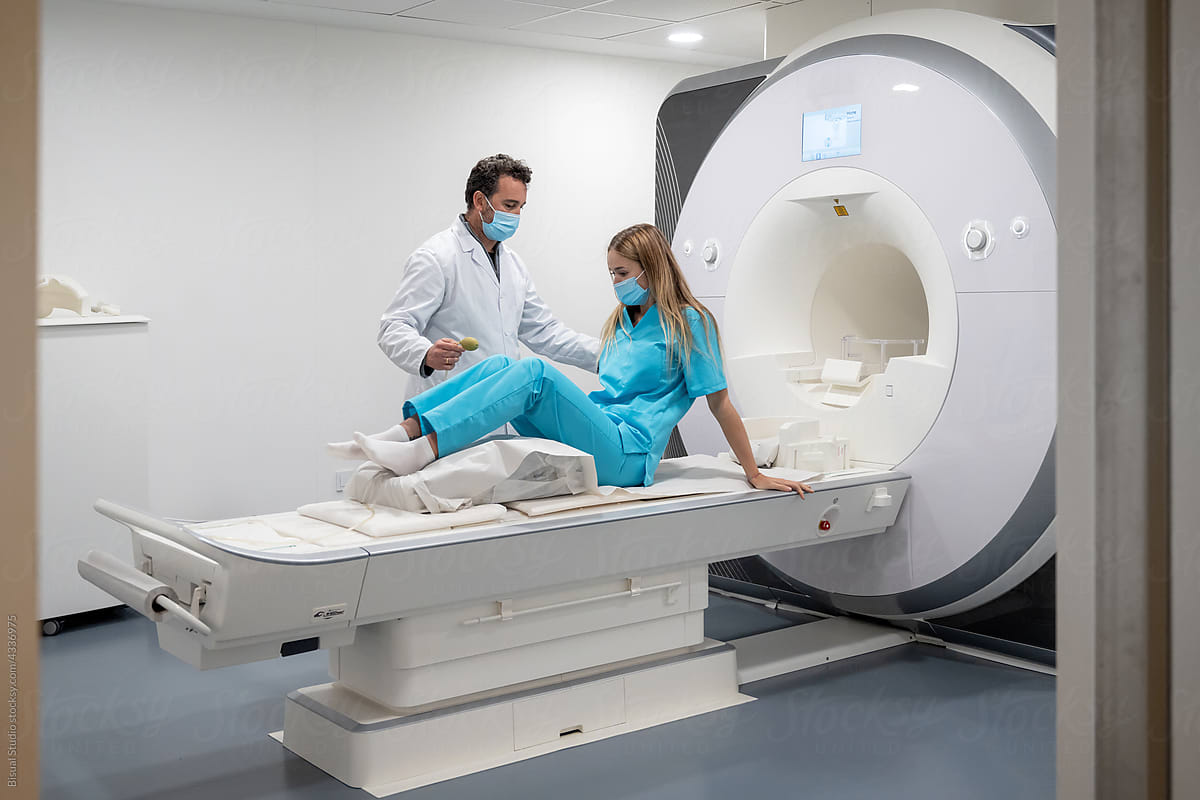Doctor helping his patient to do an MRI in hospital