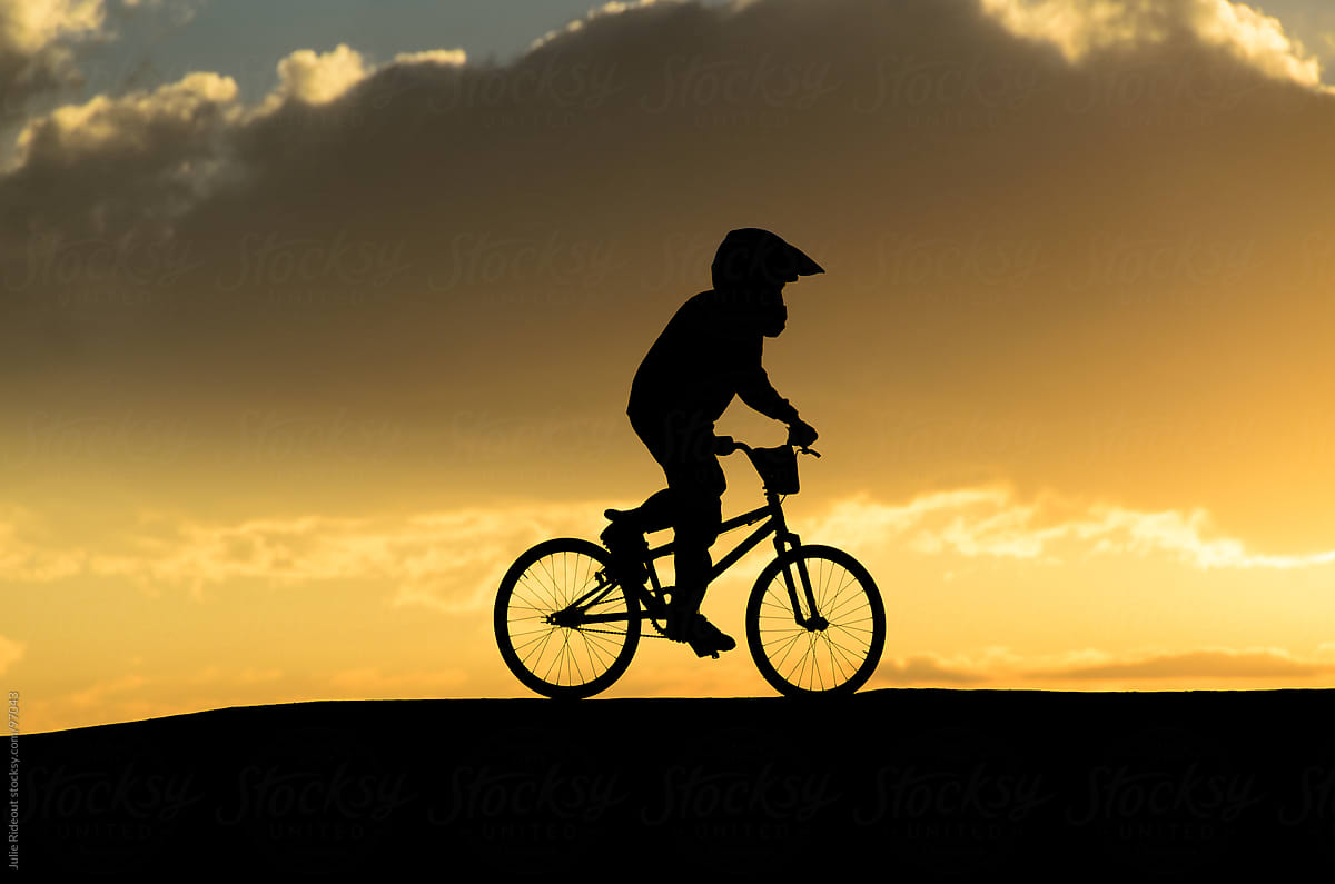 Boy Riding BMX bike at sunset