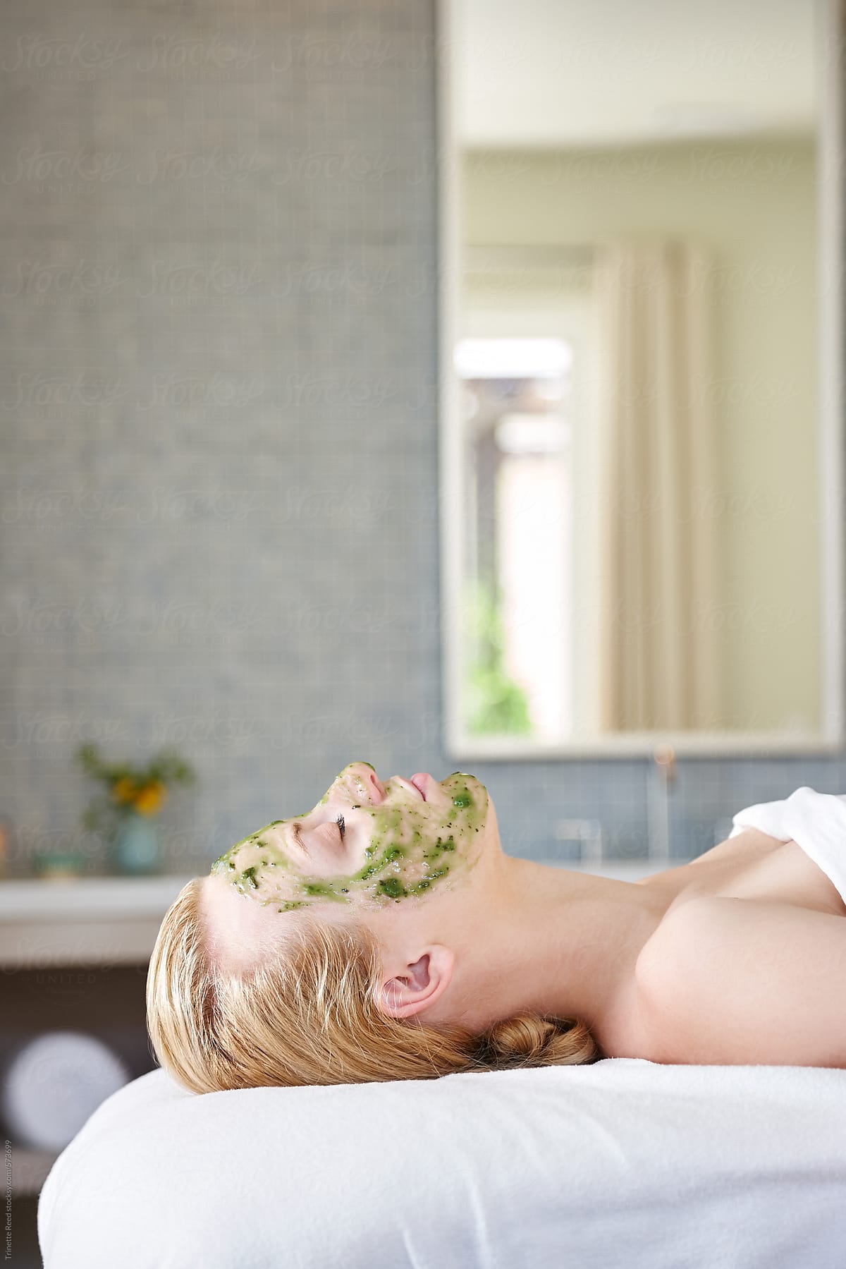 Woman receiving all natural facial at luxury spa room