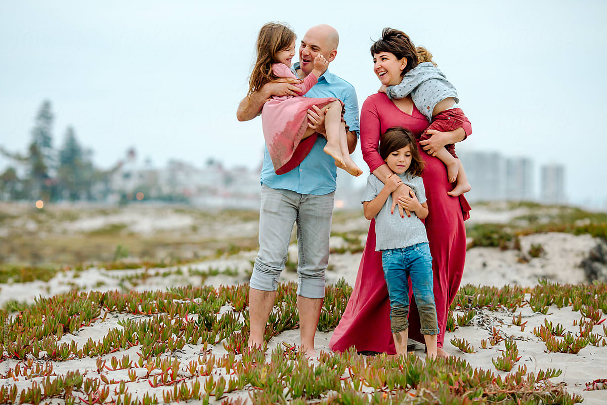 Family of five on plant-covered sand dune