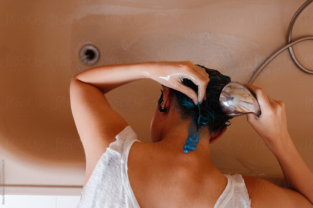 Androgyne woman top view washing hair