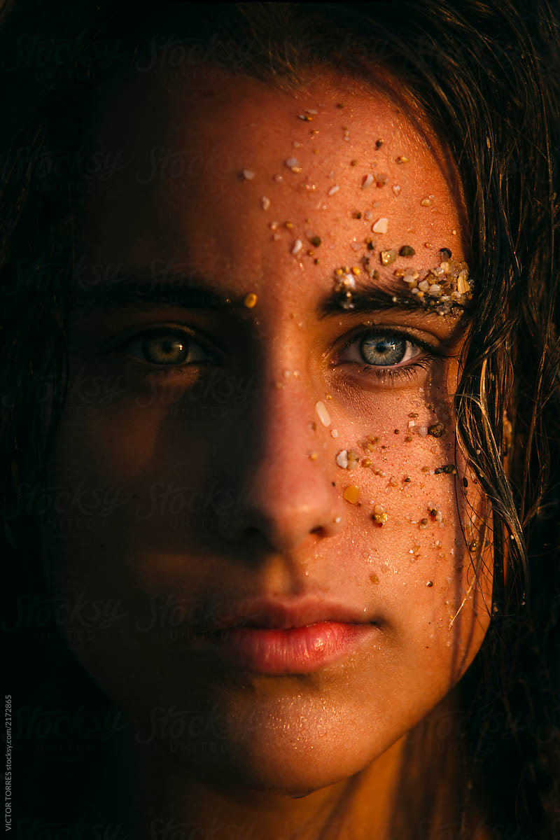 Portrait Of Cute Teen Girl With Beach Stones On Face By Victor Torres 