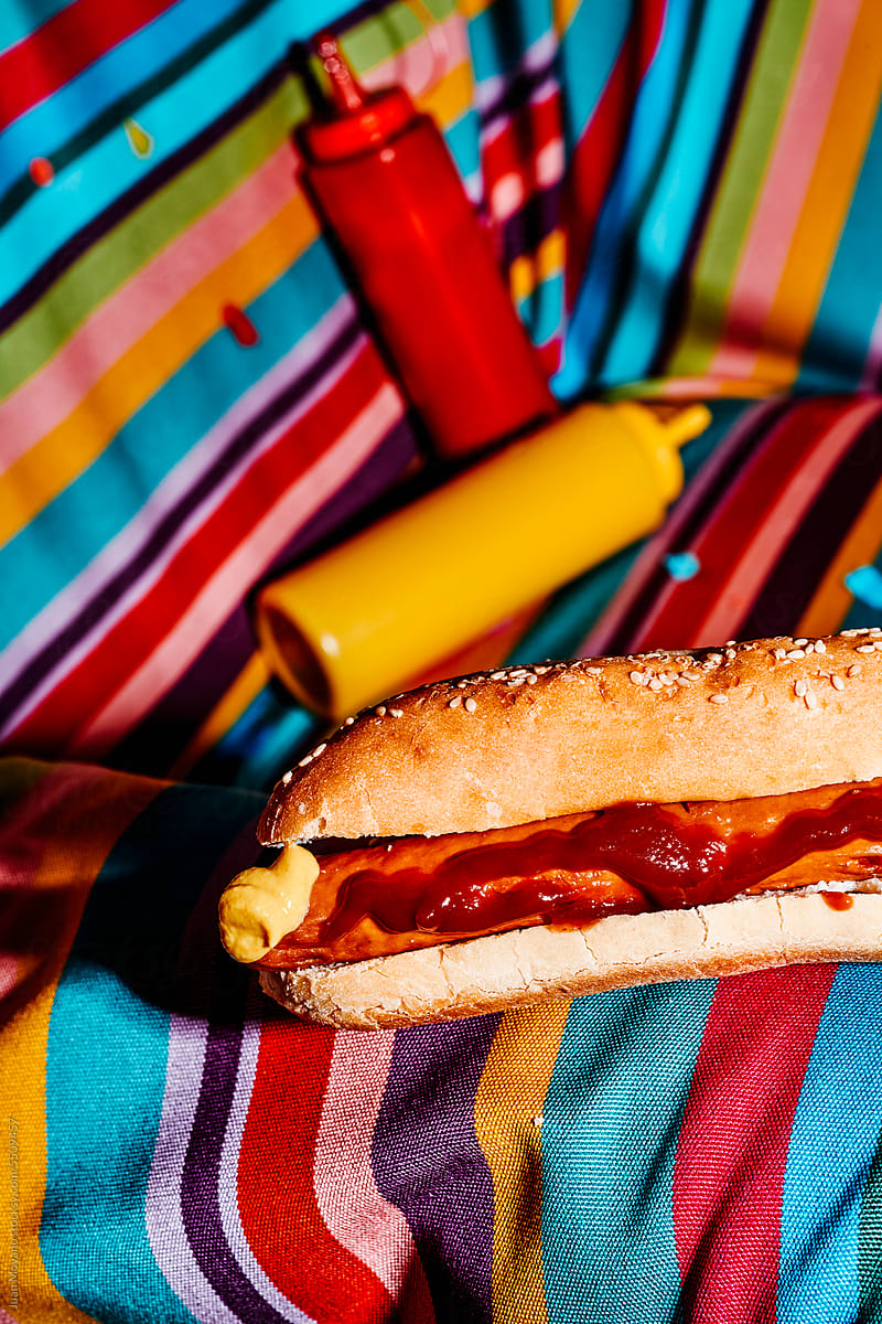 hotdog, mustard and ketchup on an armchair