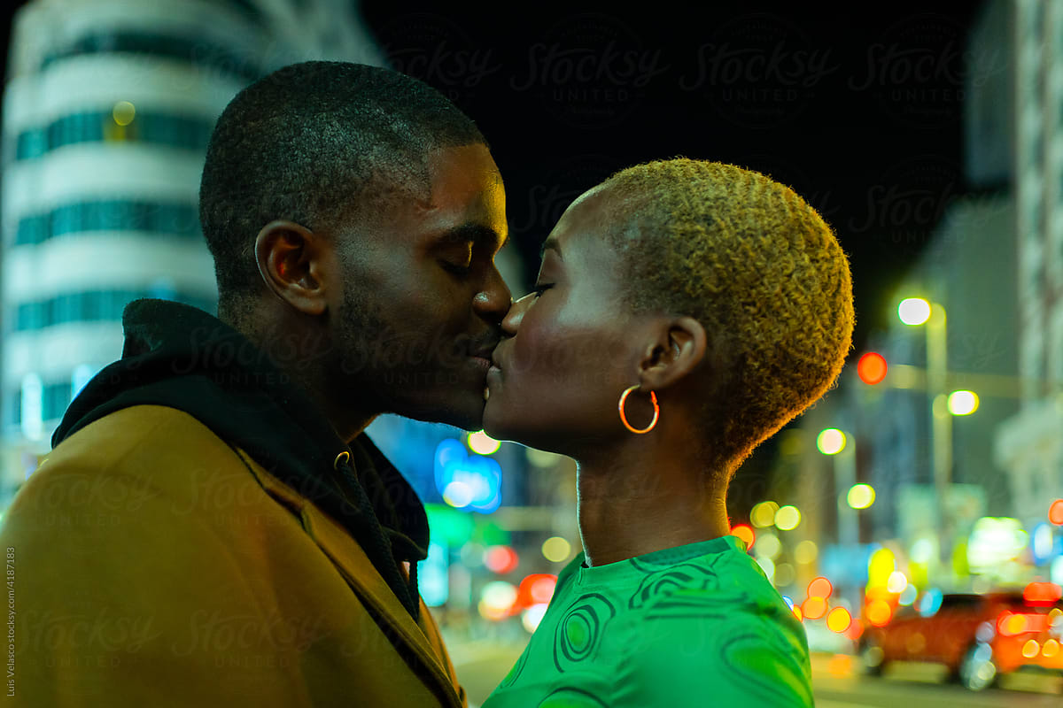 Black Couple In Love Kissing On The Street At Night.