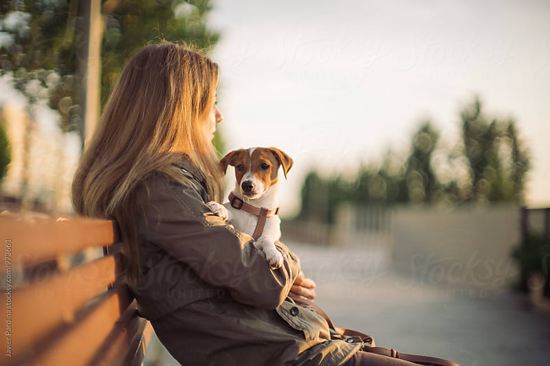 Woman sitting on a bench with dog