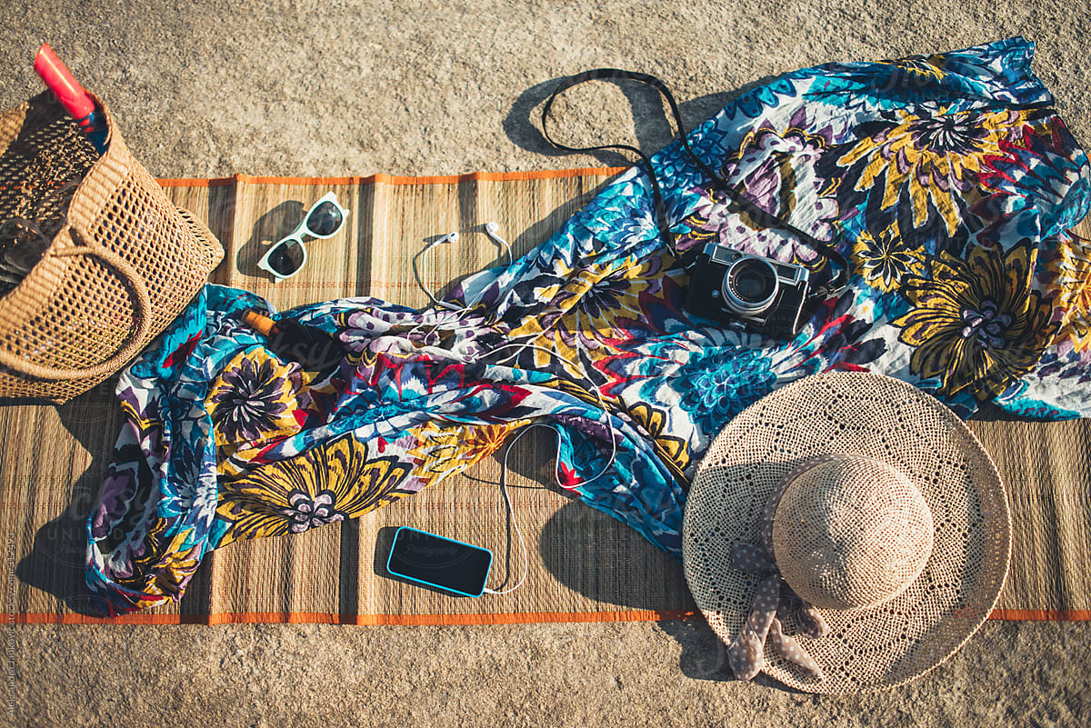 Overhead View Of Various Items And Phone On The Beach