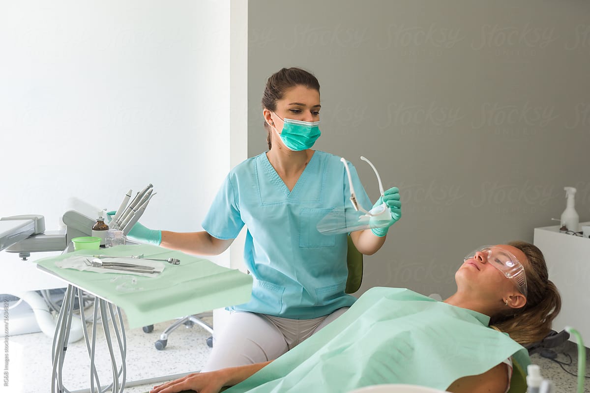 Portrait Of Female Orthodontist Treating Her Patient By Stocksy Contributor Ibex Media Stocksy