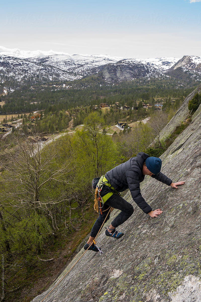Rock climbing on granite near alpine village
