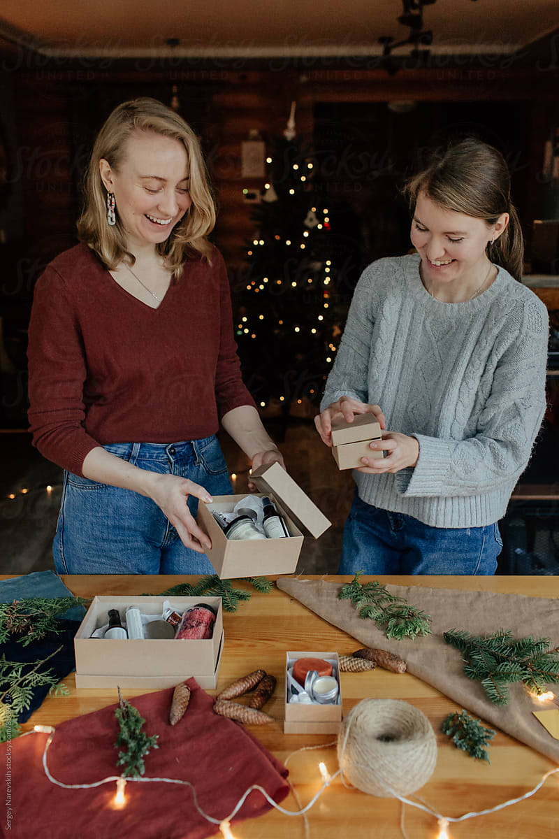 Two women collecting Christmas gifts
