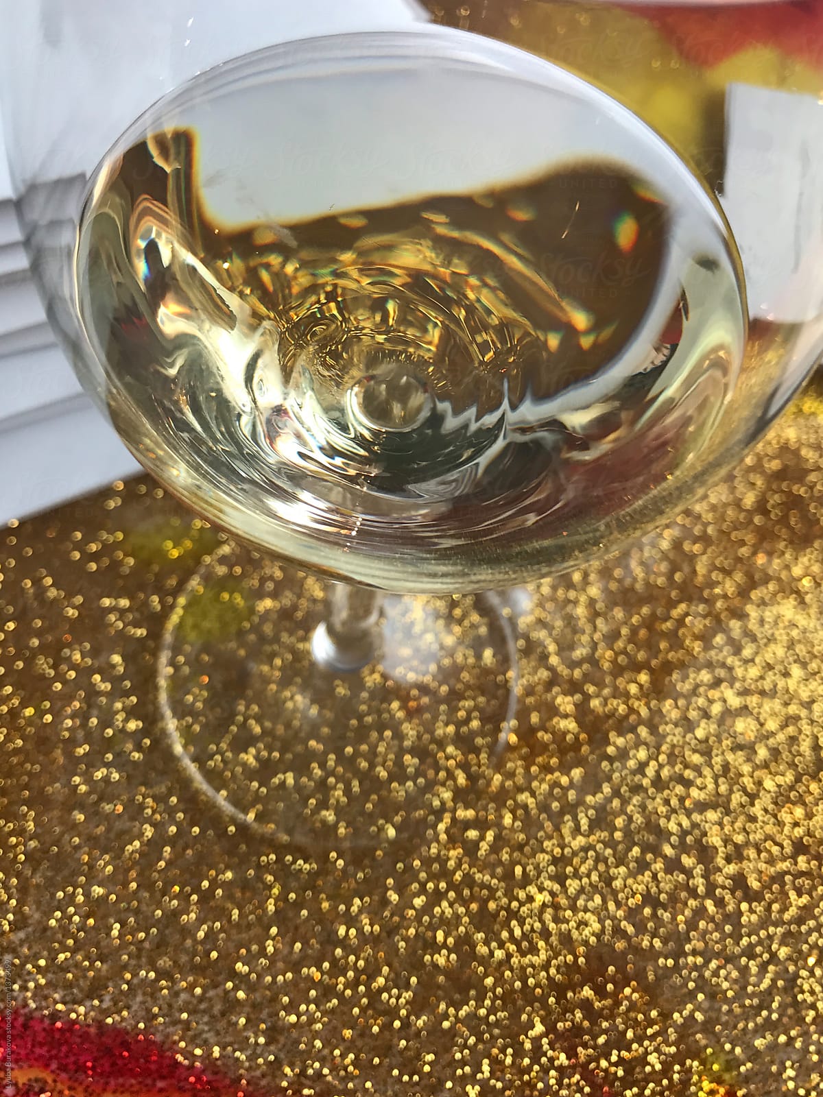 Champagne in a glass on gold glitter