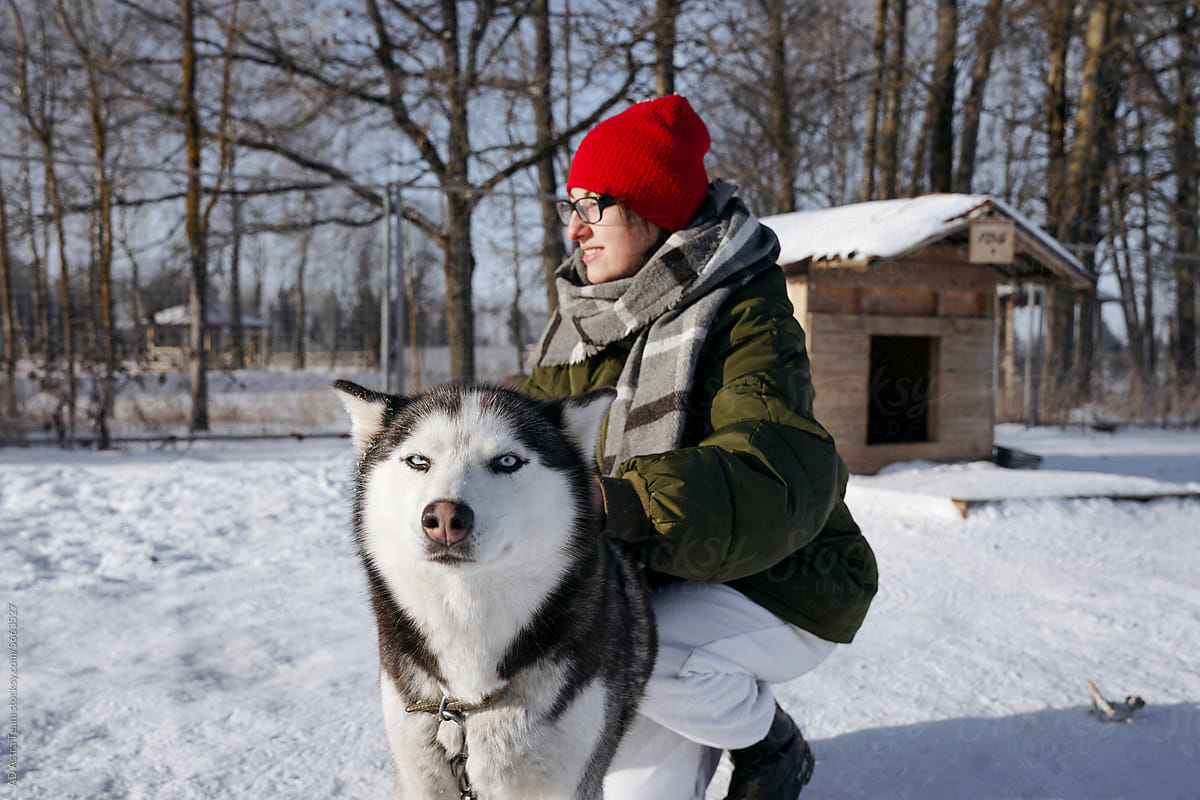Woman playing with pet on winter