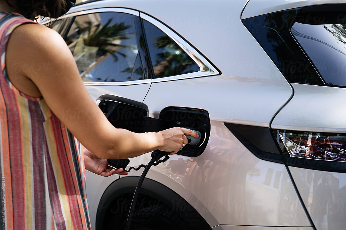 Woman charging a Electric Car