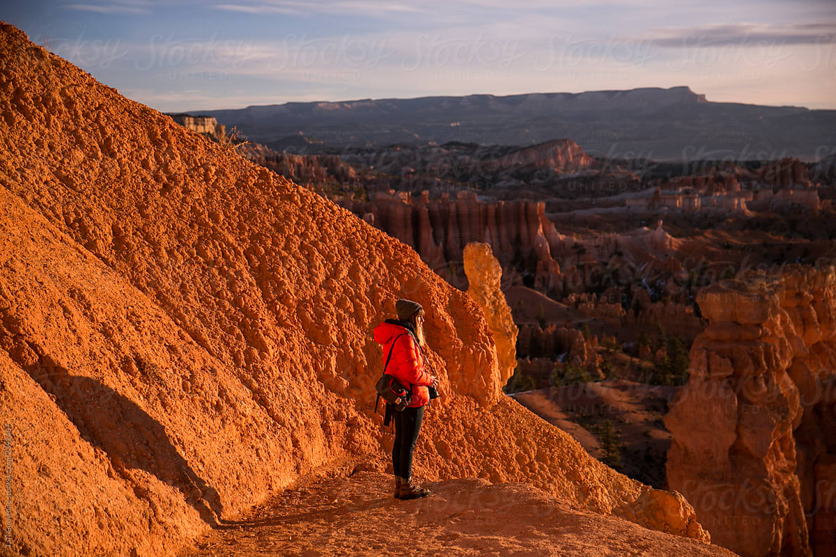 Woman takes in sunrise vista at Bryce Canyon National Park