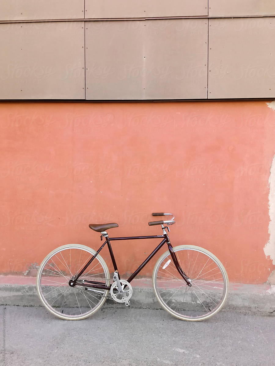 Bicycle parked near wall