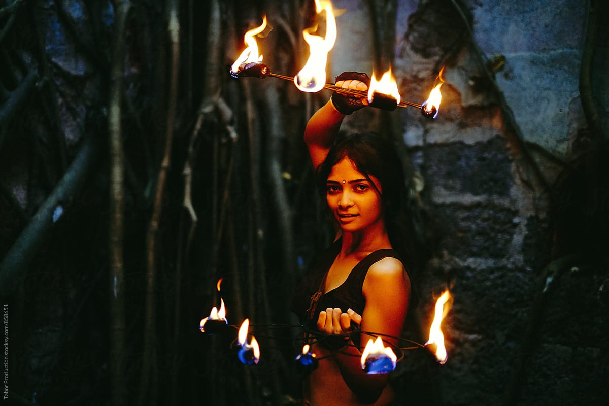 Pretty fire performer with hand flames