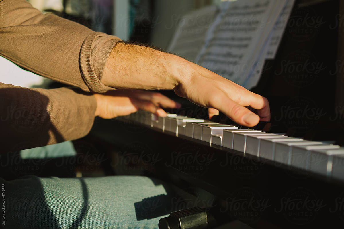 Man’s hands playing the piano