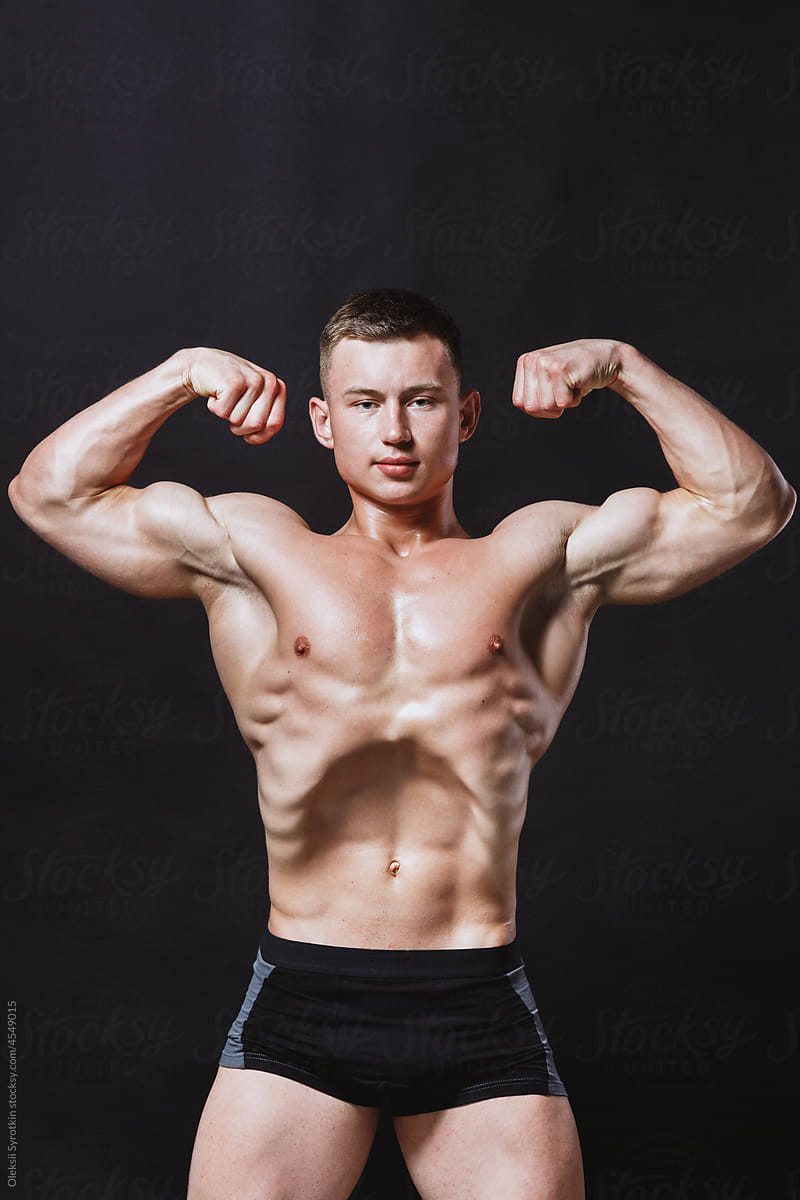 Bodybuilder working out and posing at camera