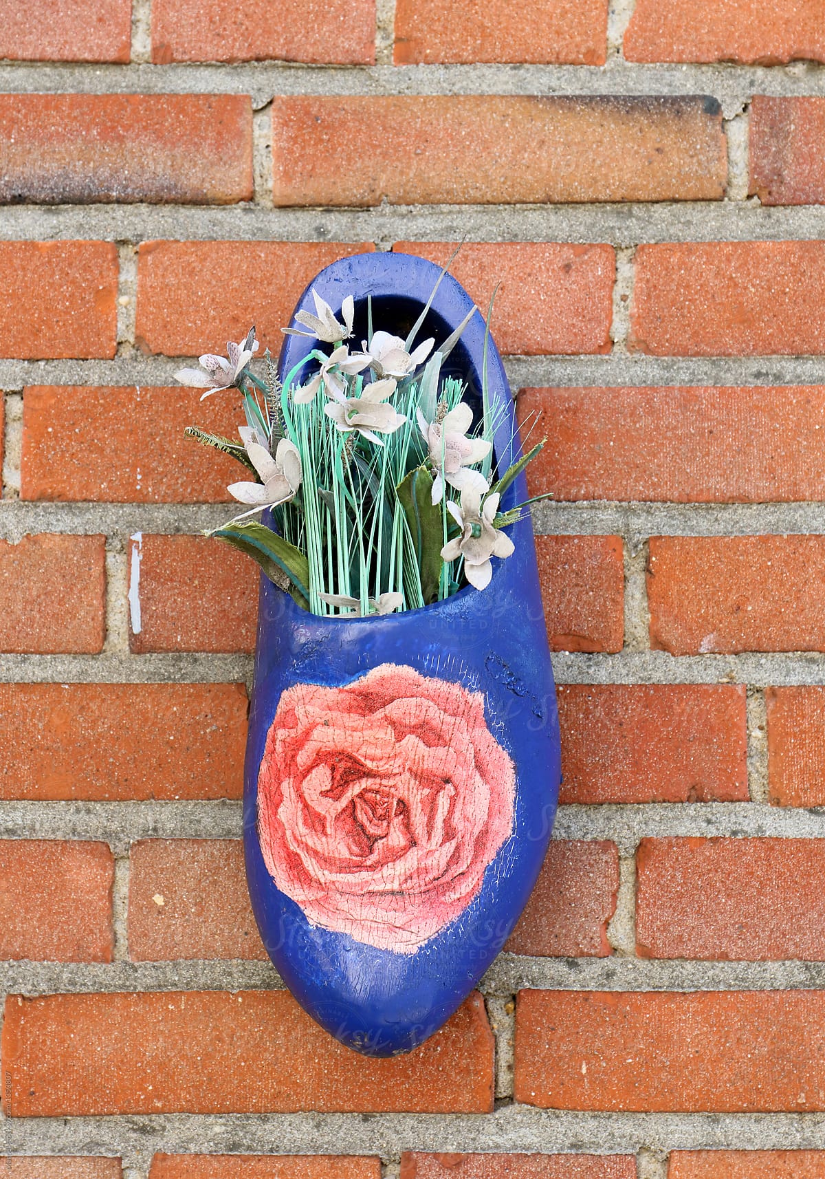 Wooden shoe with fake flowers