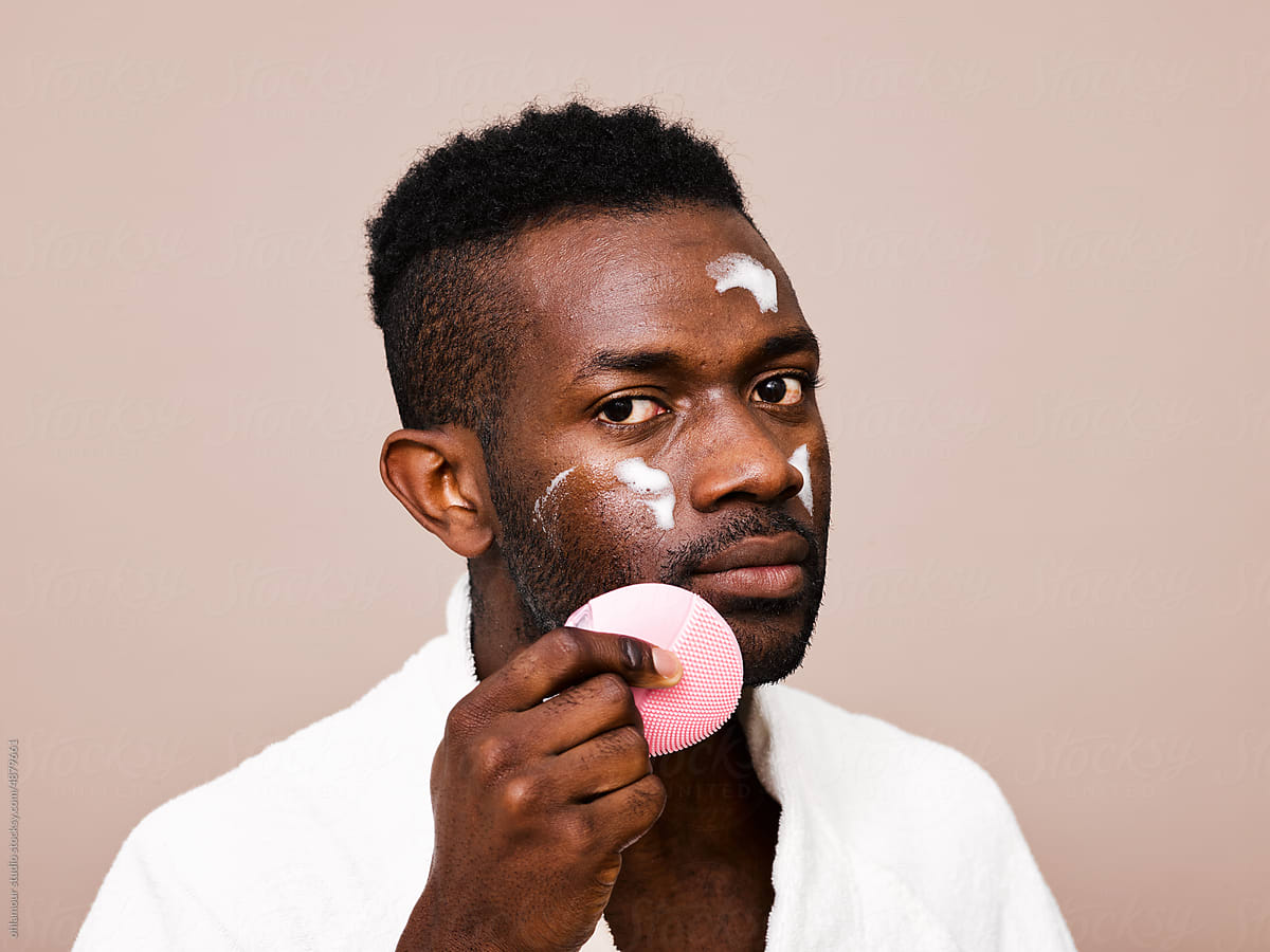Confident man using beauty products
