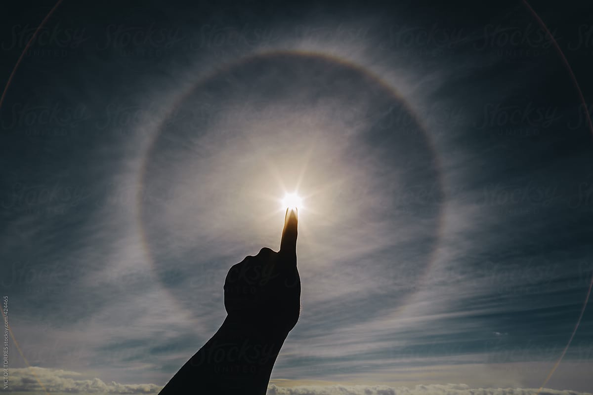 Hand Pointing a Solar Halo at the Beach