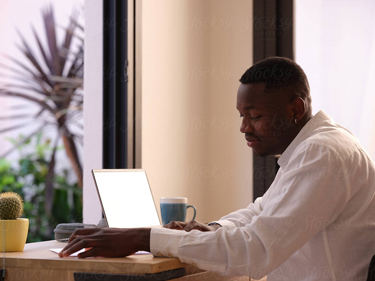 Inspired black male with papers at table