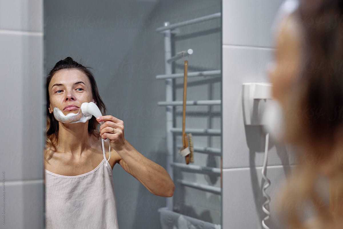Girl taking care of face in bathroom