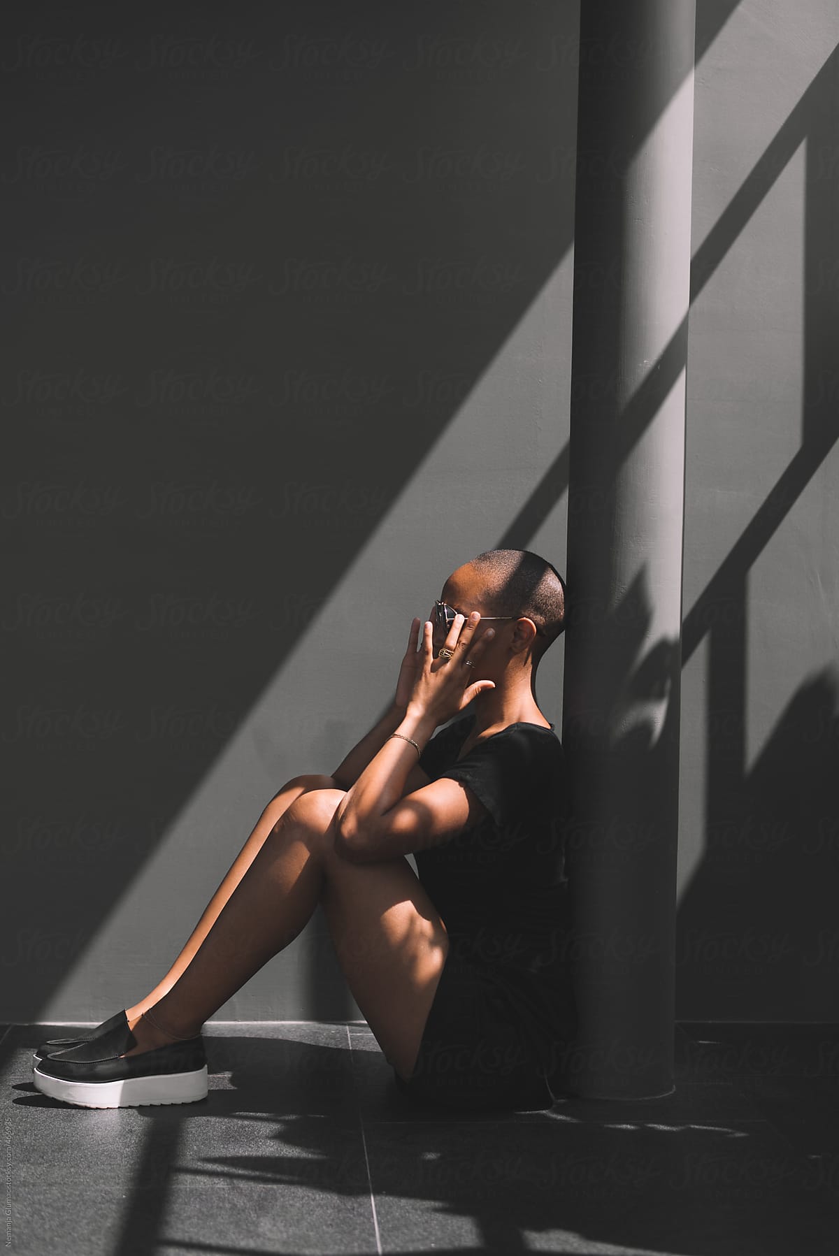 African American Woman Sitting in a Shadow
