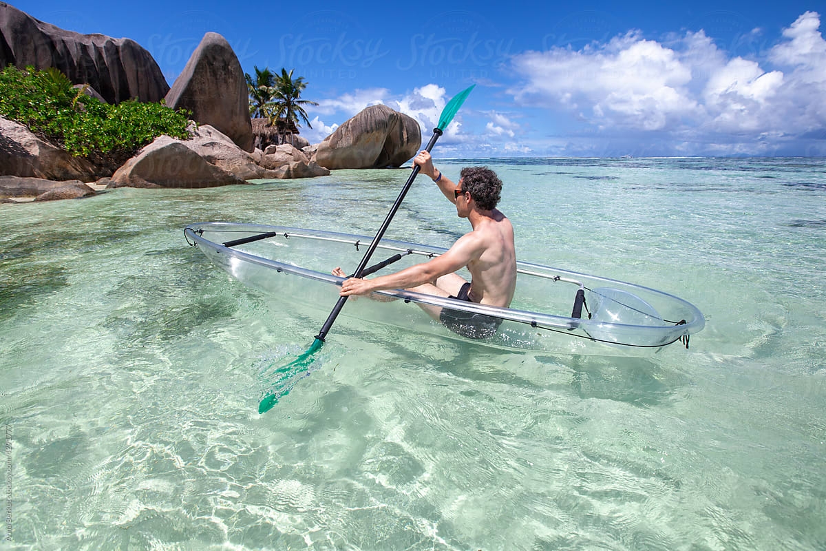 kayaking on tropical beach in Seychelles, holiday travel and tourism