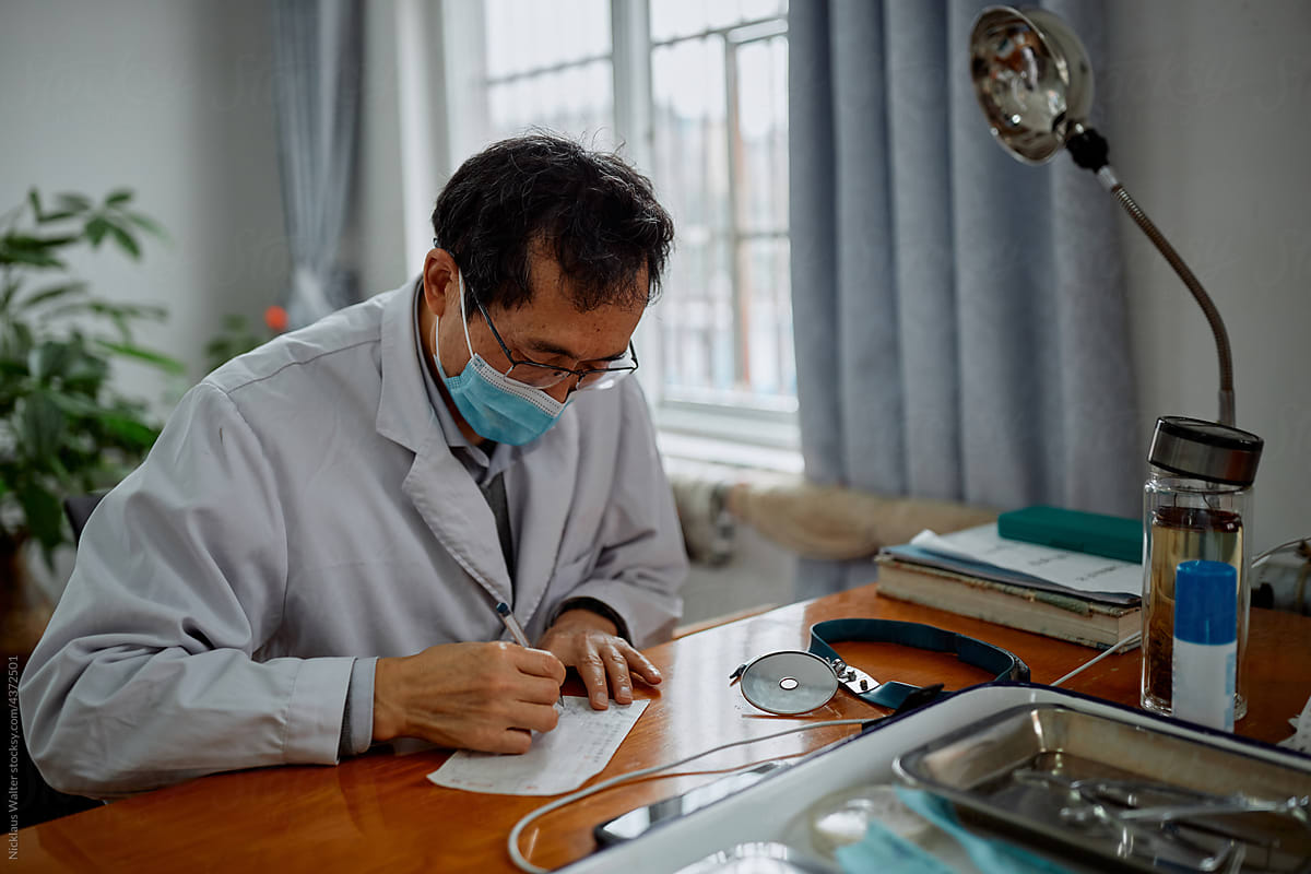 A Chinese doctor writes a prescription at the hospital
