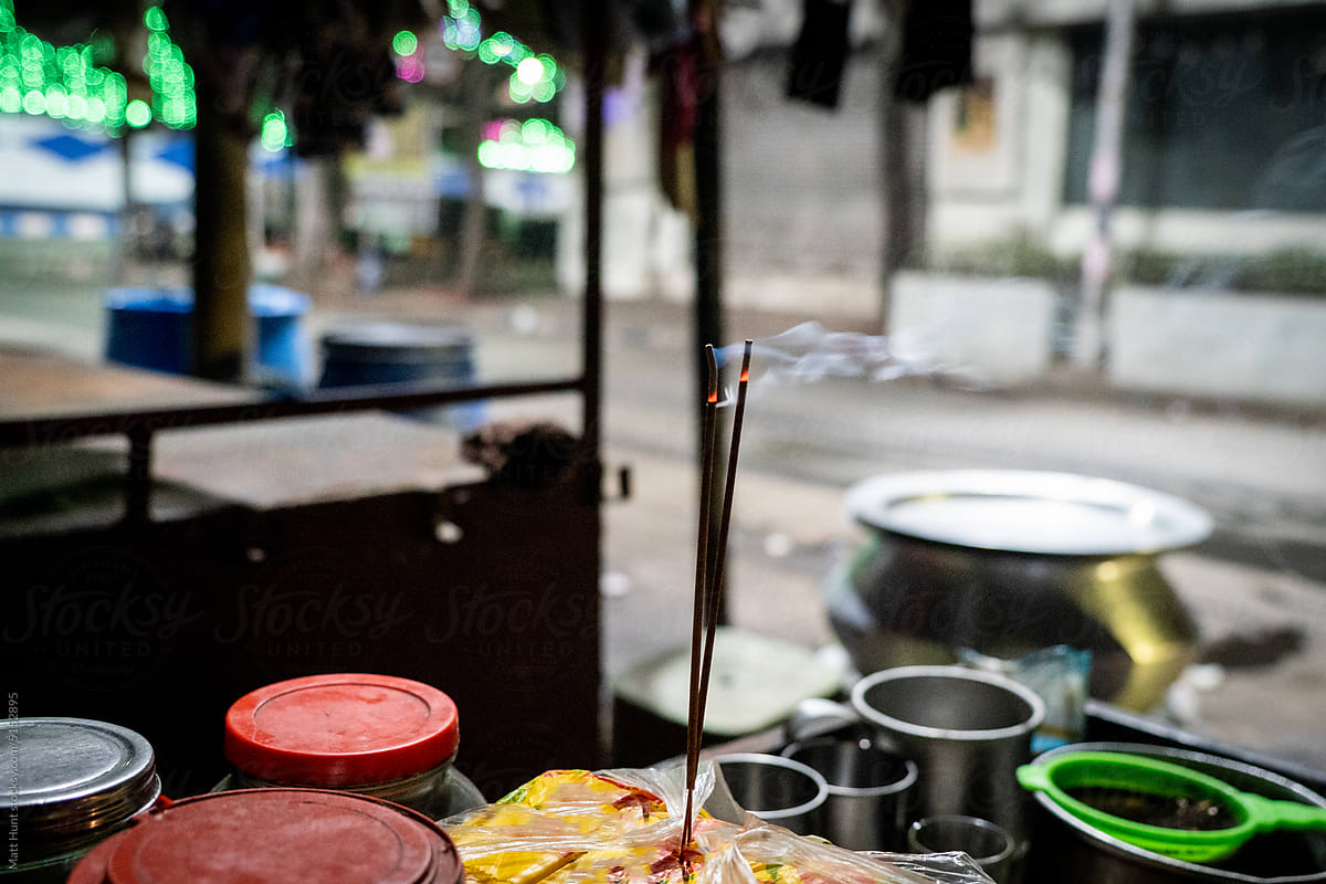 Nag champa incense sticks burning on a street food pushcart in India