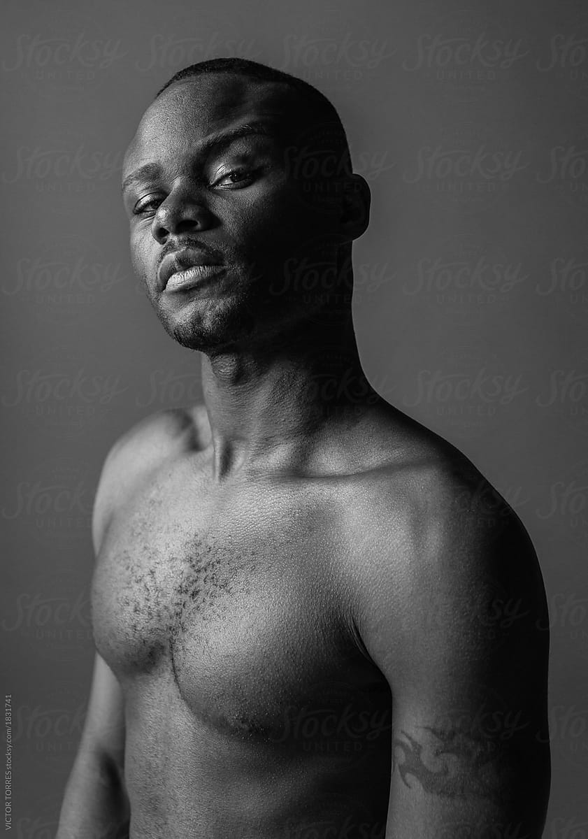 Young Black Nude Defiant Man Looking At Camera by Stocksy Contributor  VICTOR TORRES - Stocksy