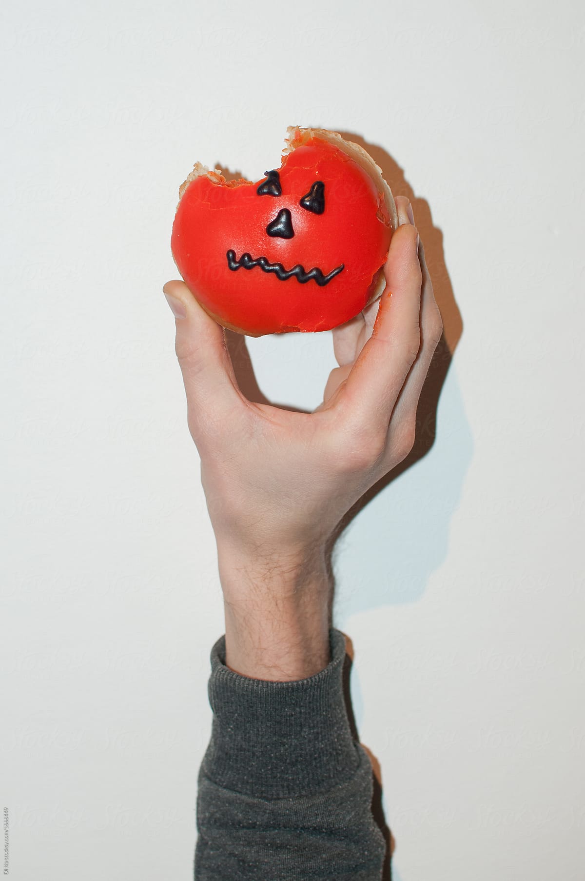 Bitten donut in the shape of a halloween pumpkin