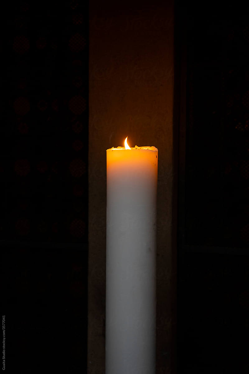 Arrangement of colorful lit candles in the dark