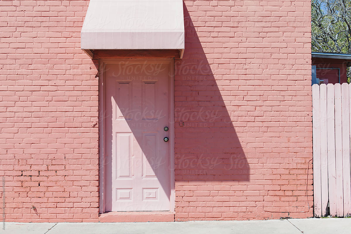 Pink door with awning on a sunny day