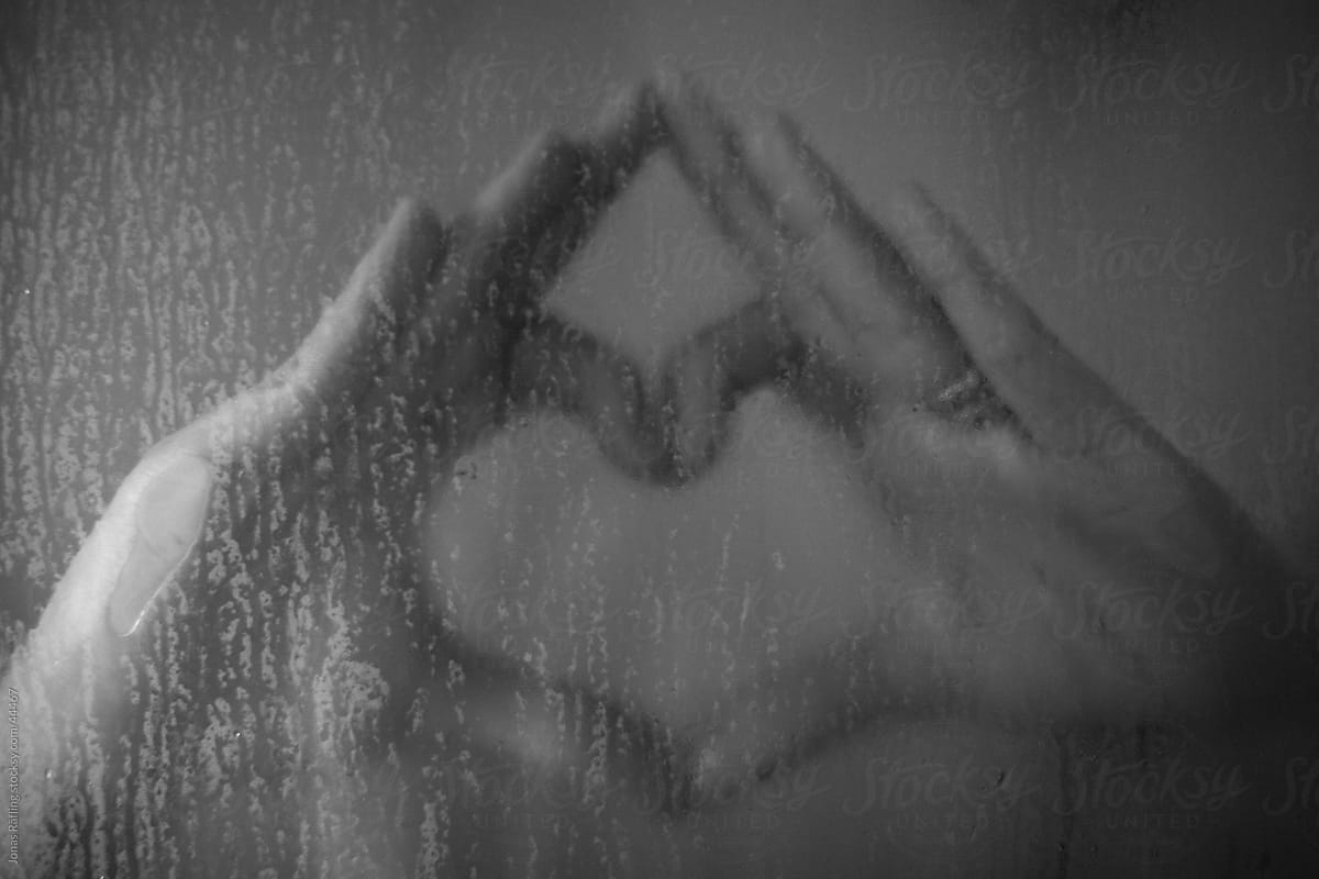 Hands making a heart in the shower
