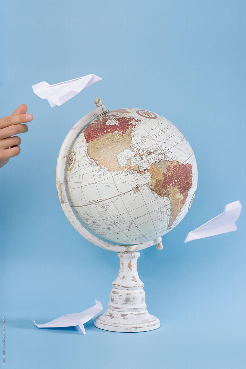 World globe with paper airplanes flying around