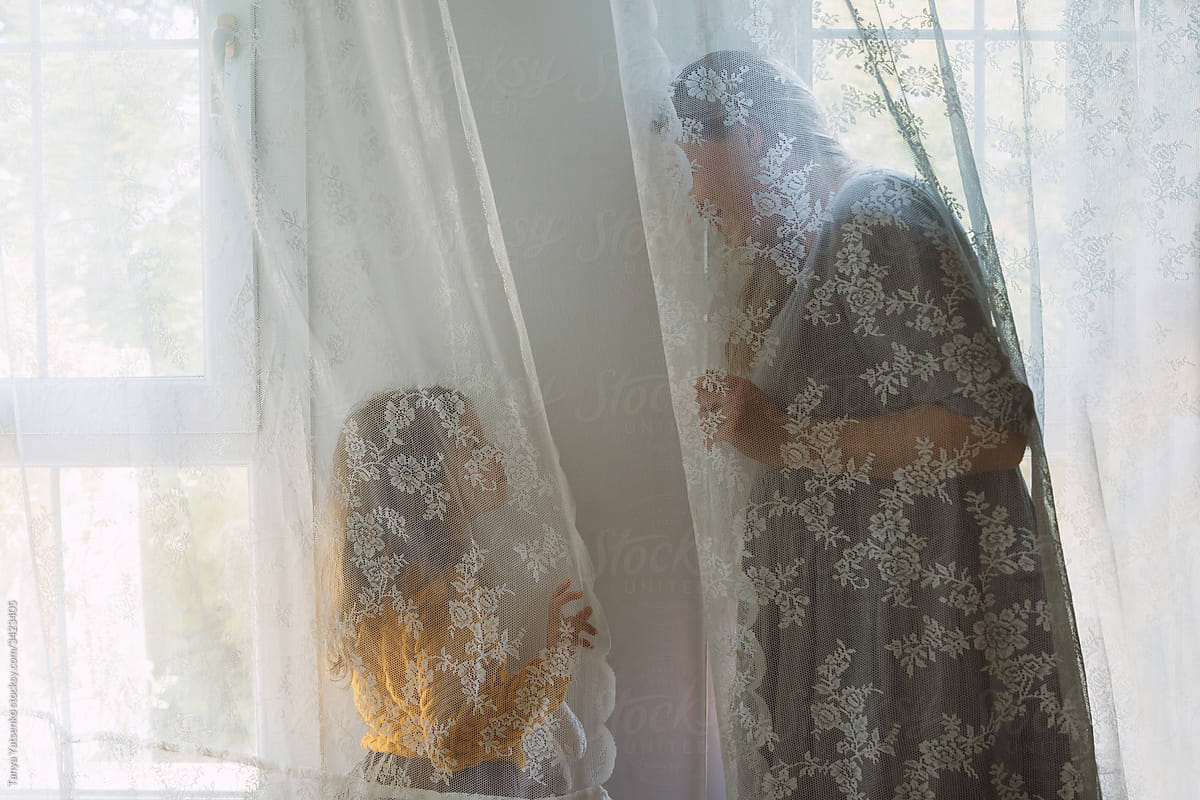 A girl and mother by the window