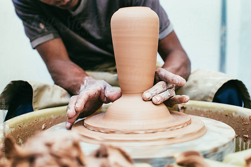 Closeup on Artisan Potter\'s Hands Making Vase on Flywheel