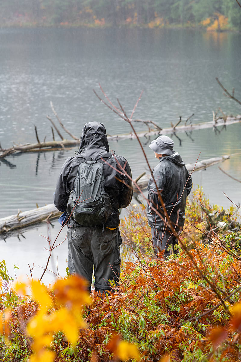 Men at Shore of Misty Mountain Lake Hiking in Autumn
