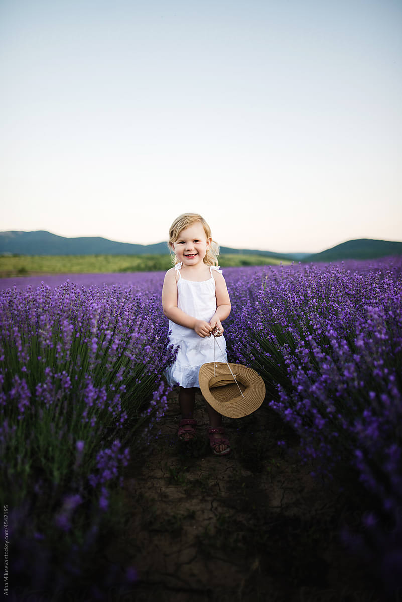 Portrait of smiling little girl in blooming lavender field