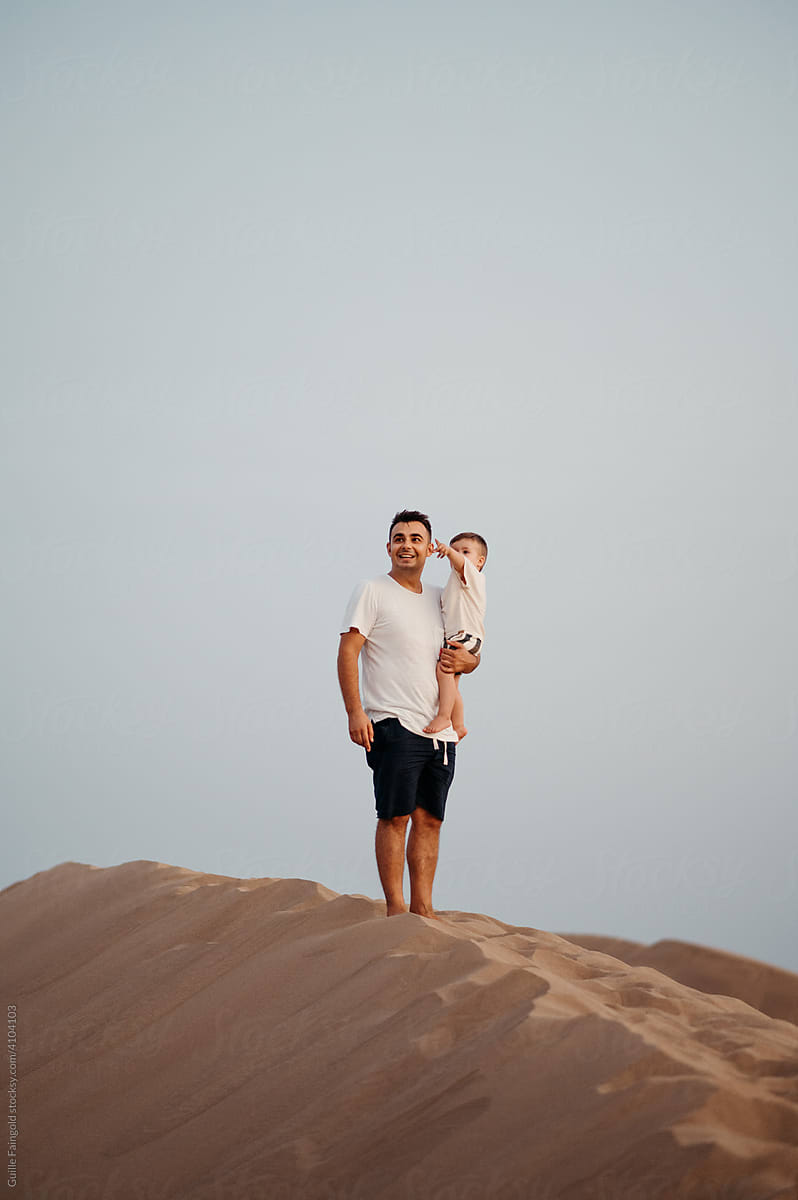Dad and son in desert.