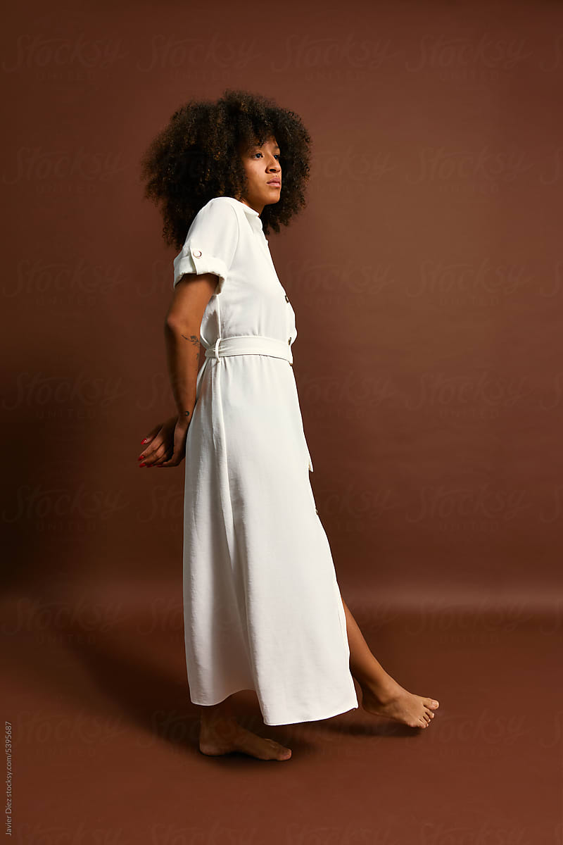 Mixed race woman in white dress