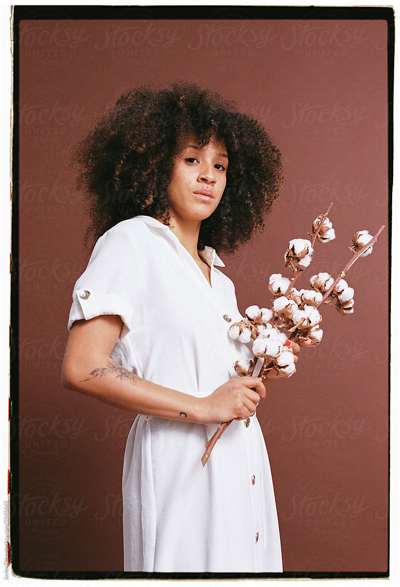 Self assured woman with cotton flowers