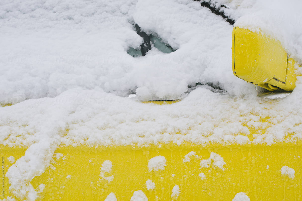Yellow car under snow