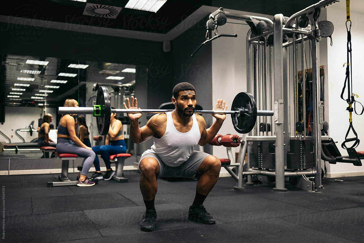 Strong man training squats in the gym