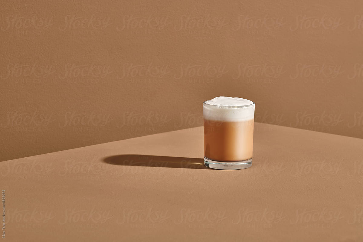 cappuccino in glass cup on wooden table