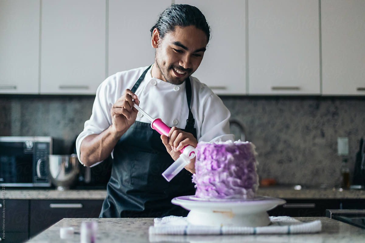 Pastry chef decorating a cake
