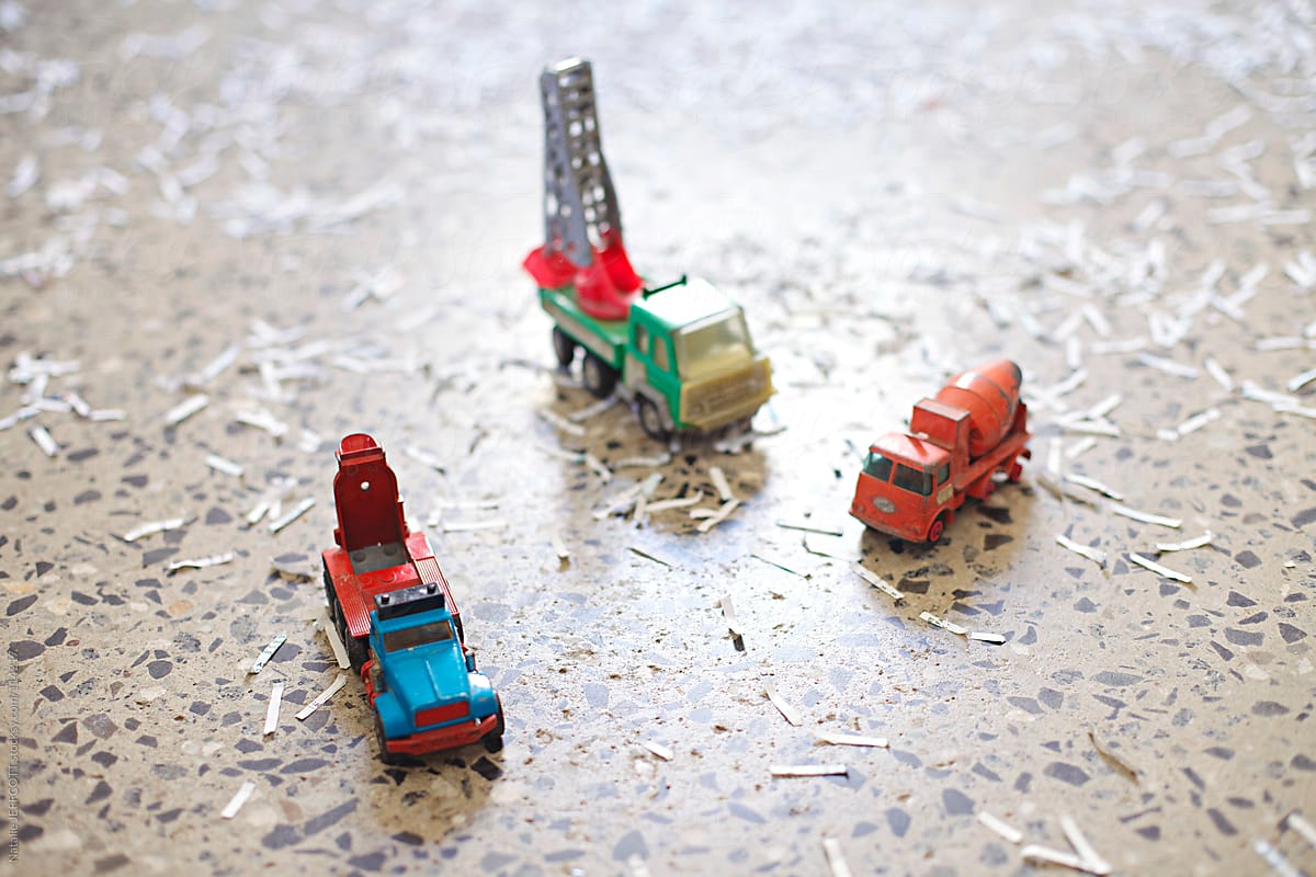 close up of toy trucks surrounded by fake snow / shredded paper