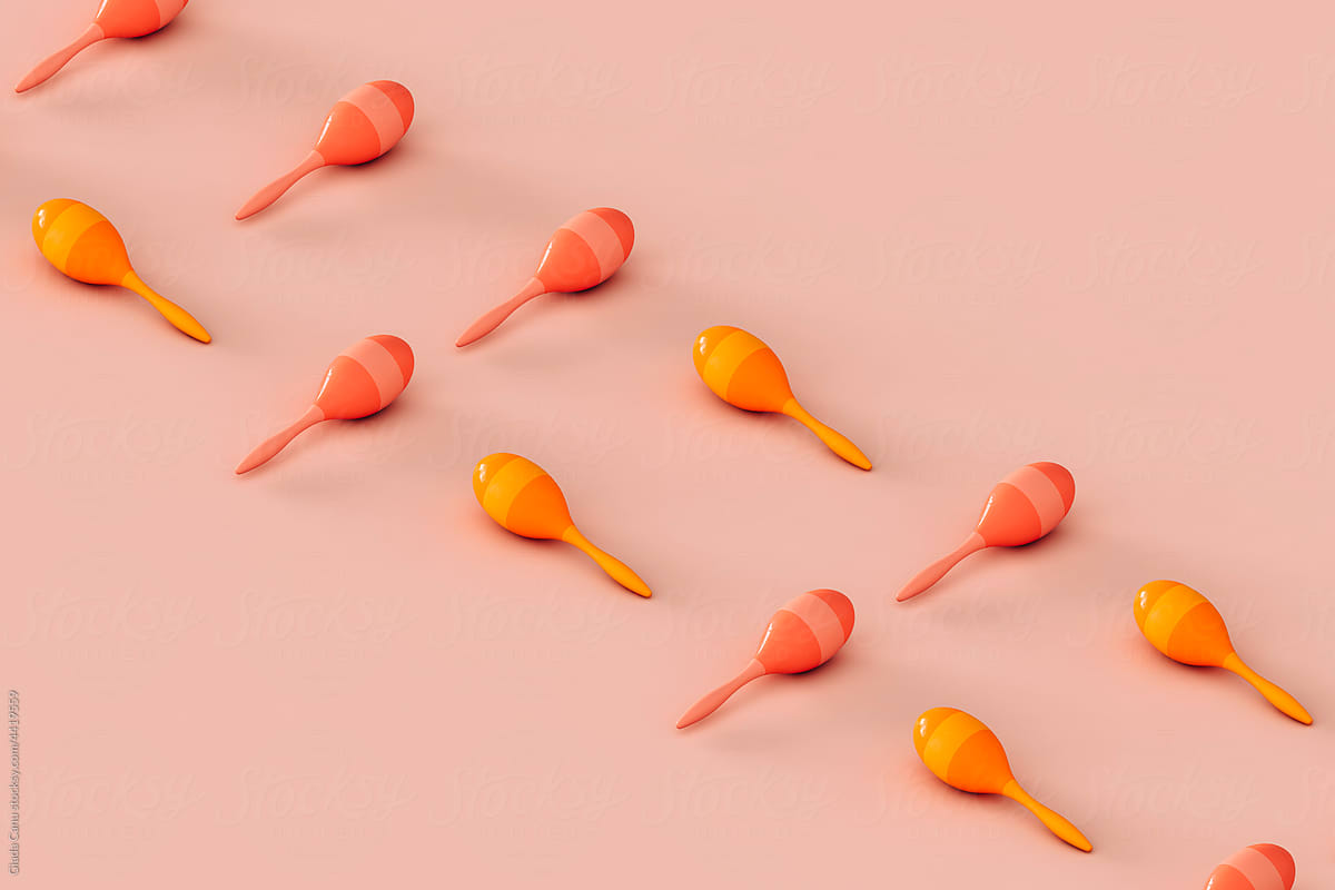 rows of colorful maracas on a pink background